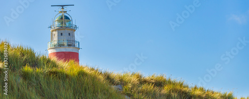 Banner close up view of Lighthouse at Waddenisland Texel, North Holland, Netherlands photo