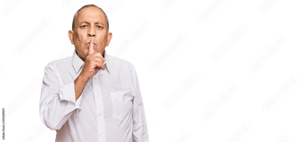 Handsome senior man wearing elegant white shirt asking to be quiet with finger on lips. silence and secret concept. Handsome senior man wearing elegant white shirt asking to be quiet with finger on lips. silence and secret concept.
