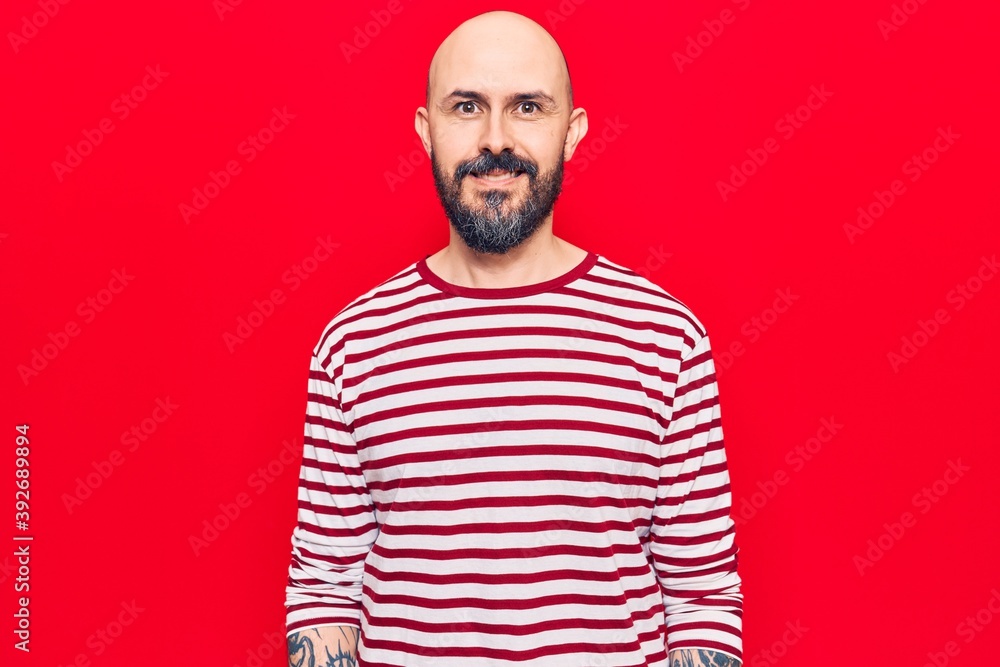 Fototapeta premium Young handsome man wearing casual clothes looking positive and happy standing and smiling with a confident smile showing teeth