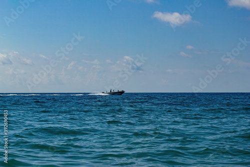 Seascape with a boat running on the waves
