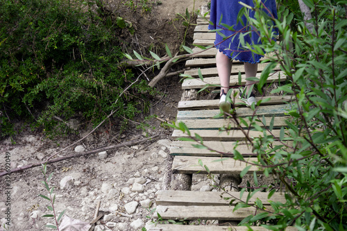 woman crossing dry riverband photo