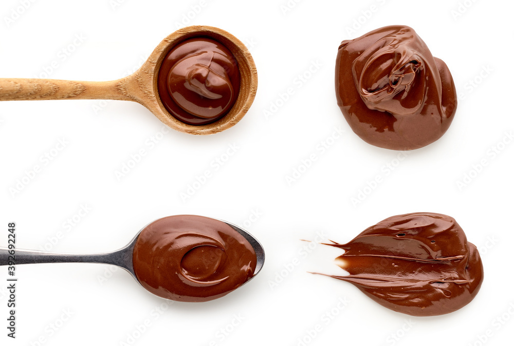Chocolate cream in spoons isolated on white background, top view Chocolate cream in spoons isolated on white background, top view