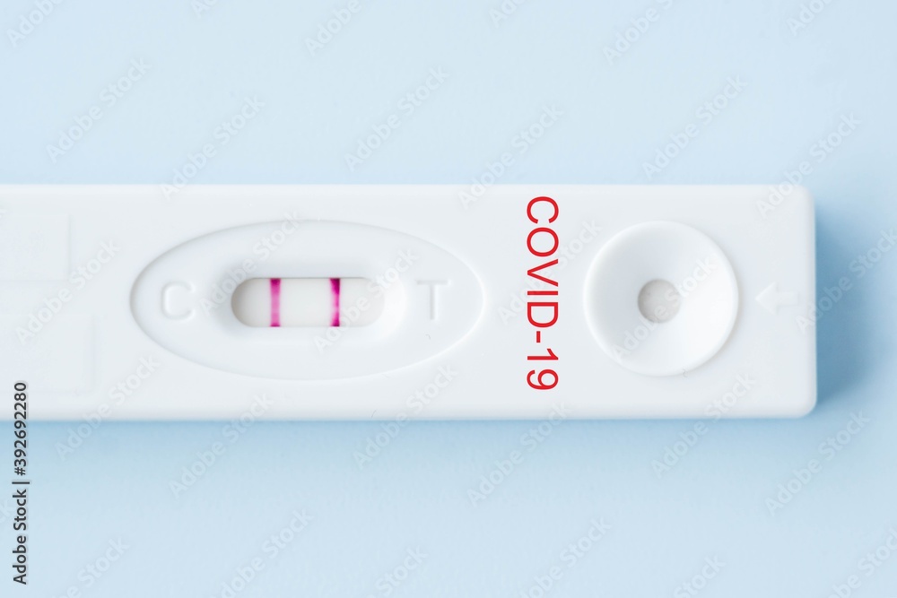 Positive result of coronavirus, covid-19 quick test on blue background. Corona testing, epidemic control of infected amount concept.