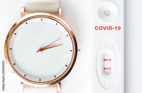 Obraz na płótnie Positive result of coronavirus, covid-19 test with white clock on white background. Corona testing, epidemic control concept. w salonie