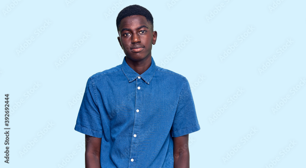 Fototapeta premium Young african american man wearing casual clothes looking sleepy and tired, exhausted for fatigue and hangover, lazy eyes in the morning.