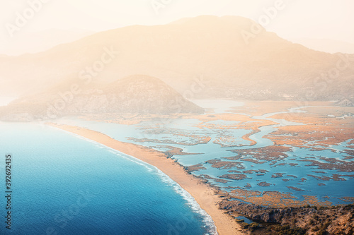 Fototapeta Naklejka Na Ścianę i Meble -  Scenic aerial paniramic view from mountain Bozburun to Iztuzu beach and the Dalyan river Delta as well as lake Sulungur at sunset time. Majestic autumn landscape. Explore natural wonders of Turkey
