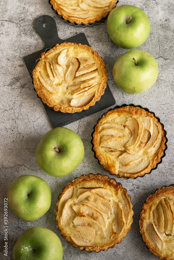 Ready to eat apple pies on grey background Ready to eat apple pies on grey background