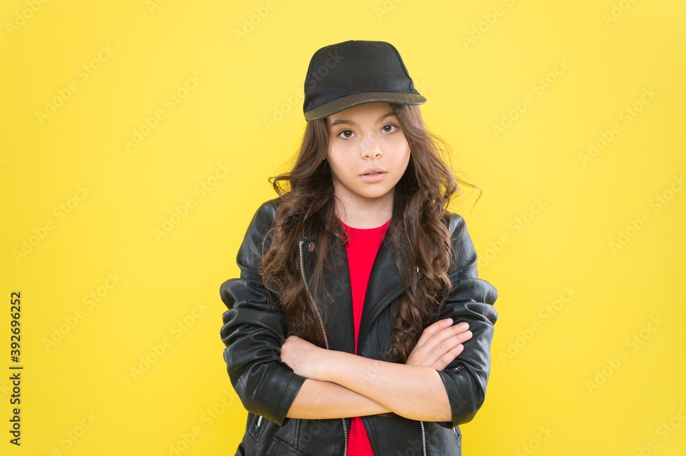 Casual look. Little kid keep arms crossed yellow background. Wearing casual style. Trendy childrens wear. Fashion streetwear. We promise comfort Casual look. Little kid keep arms crossed yellow background. Wearing casual style. Trendy childrens wear. Fashion streetwear. We promise comfort