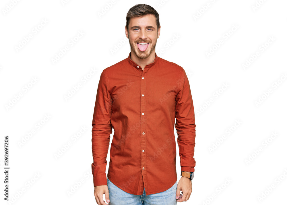 Fototapeta premium Handsome caucasian man wearing casual clothes sticking tongue out happy with funny expression. emotion concept.