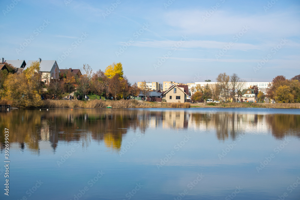 Photo of a n autumn landscape with a lake and cozy nordic houses in Vilnius