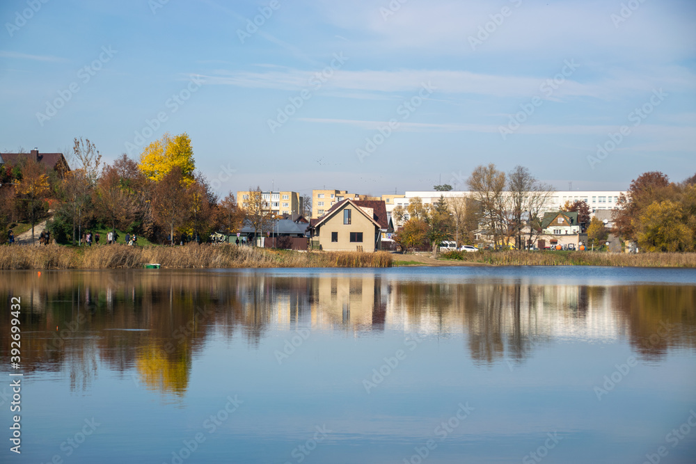 Photo of a n autumn landscape with a lake and cozy nordic houses in Vilnius