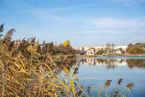 Photo of a n autumn landscape with a lake and cozy nordic houses in Vilnius