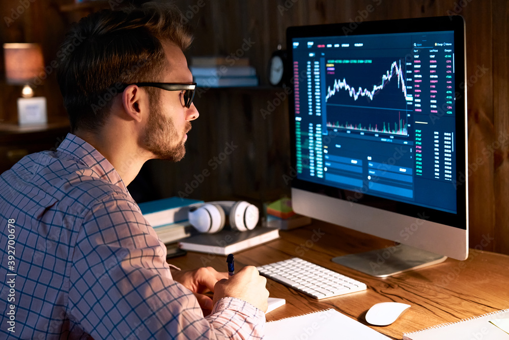 Serious business man trader analyst looking at computer monitor, investor broker analyzing indexes, financial chart trading online investment data on cryptocurrency stock market graph on pc screen. Serious business man trader analyst looking at computer monitor, investor broker analyzing indexes, financial chart trading online investment data on cryptocurrency stock market graph on pc screen.