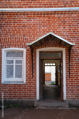 Window and entrance on a red brick wall.