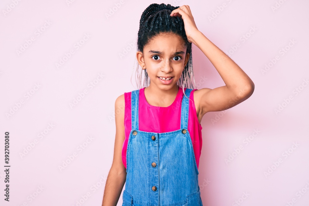 Young african american girl child with braids wearing casual clothes over pink background confuse and wonder about question. uncertain with doubt, thinking with hand on head. pensive concept. Young african american girl child with braids wearing casual clothes over pink background confuse and wonder about question. uncertain with doubt, thinking with hand on head. pensive concept.