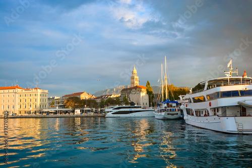 Morning at Riva Harbor on the Adriatic coast of Croatia in the ancient city of Split with boats in the sea and sunlight hitting the Split Cathedral