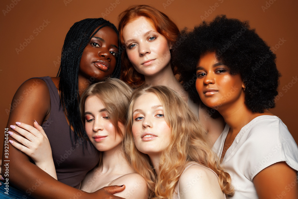 young pretty caucasian, afro, scandinavian woman posing cheerful together on brown background, lifestyle diverse nationality people concept young pretty caucasian, afro, scandinavian woman posing cheerful together on brown background, lifestyle diverse nationality people concept