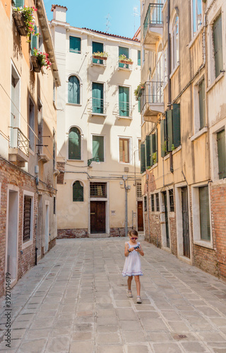 ruelle de Venise avec une fille tenant un appareil photo dans les mains