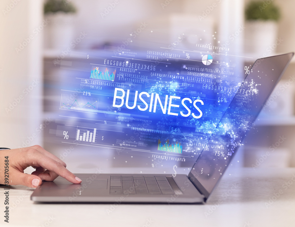 Closeup of businessman hands working on laptop with BUSINESS inscription, succesfull business concept Closeup of businessman hands working on laptop with BUSINESS inscription, succesfull business concept