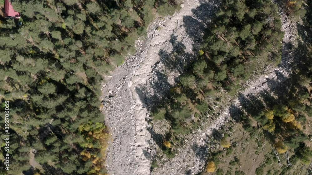 Rocky river flow top view from drone above. Rapid Baksan river streaming on Glade Azau in natural reserve Kabardino Balkaria. Wild mountain nature aerial drone view. Rocky river flow top view from drone above. Rapid Baksan river streaming on Glade Azau in natural reserve Kabardino Balkaria. Wild mountain nature aerial drone view.