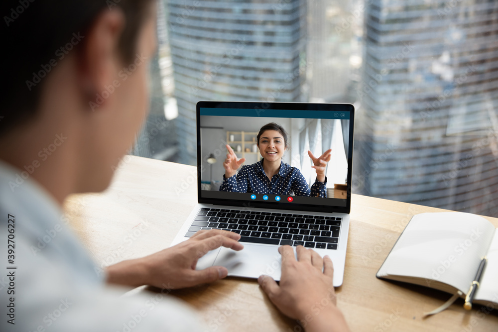 Focus on computer video call application screen happy friendly indian ethnicity businesswoman holding online meeting with colleague, consulting client remotely or mentoring employee distantly.