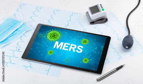 Close-up view of a tablet pc with MERS inscription, microbiology concept