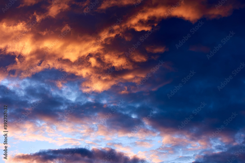 Sunset blue sky with large orange clouds