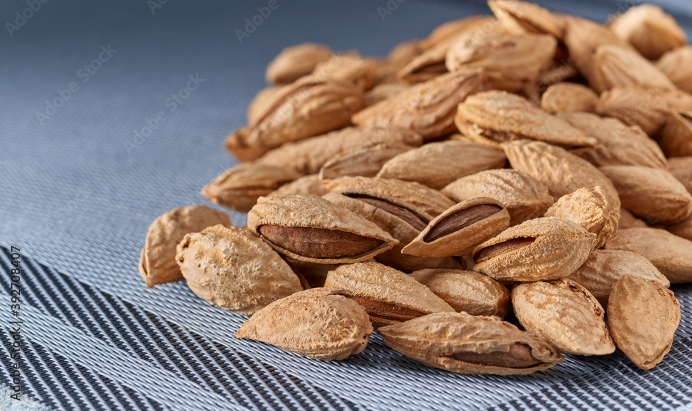 Roasted salted almonds lie on a light background.