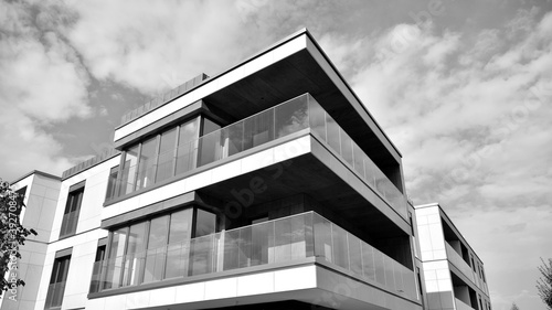 Detail of modern residential flat apartment building exterior. Fragment of new luxury house and home complex. Black and white.