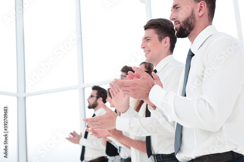 close up.smiling business team applauds standing
