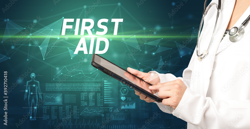 doctor writes notes on the clipboard with FIRST AID inscription, medical diagnosis concept doctor writes notes on the clipboard with FIRST AID inscription, medical diagnosis concept
