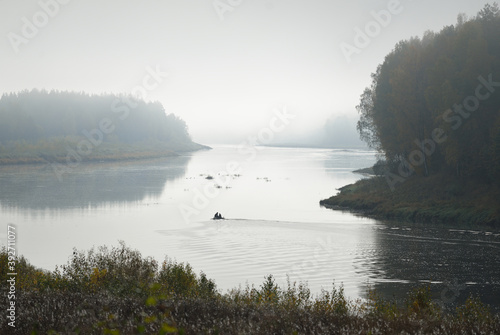 Panoramic view of majestic golden birch forest and bends of Daugava river in a fog. Autumn. Daugavas loki nature park, Latgale, Latvia. Ecology, ecotourism, recreation, travel destinations, landmark photo