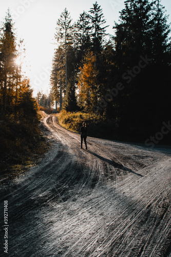 A girl hiking up the mountain on a curved track with warm sunset light. Grane Dam, Granetalsperre, Harz Mountains photo