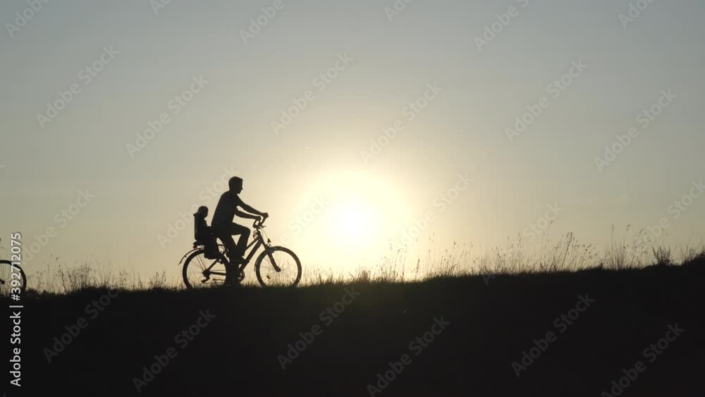 Silhouettes of a large large family on bicycles at sunset. Silhouettes of a large large family on bicycles at sunset.