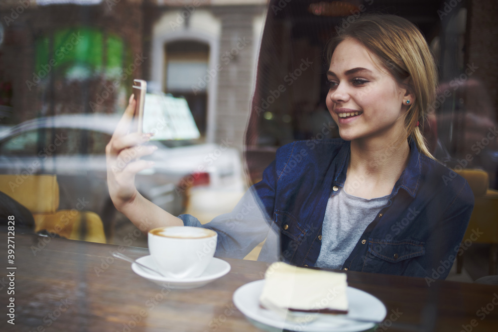 Woman sitting at a cafe table having a snack in the morning lifestyle leisure socializing Woman sitting at a cafe table having a snack in the morning lifestyle leisure socializing