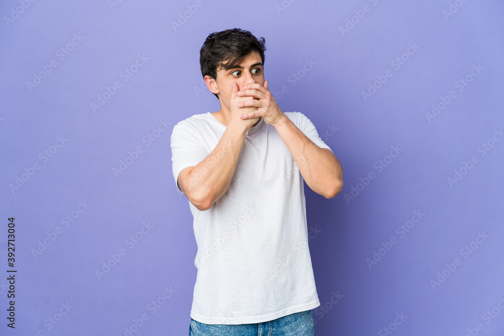 Young cool man thoughtful looking to a copy space covering mouth with hand. Young cool man thoughtful looking to a copy space covering mouth with hand.