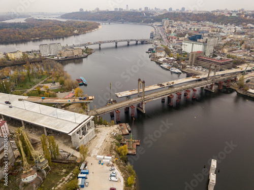 Bridge construction site in Kiev. Cloudy autumn morning. Aerial drone view.