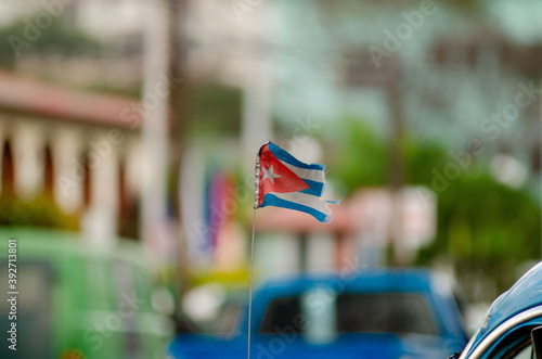 Deteriorated Cuban flag on a car