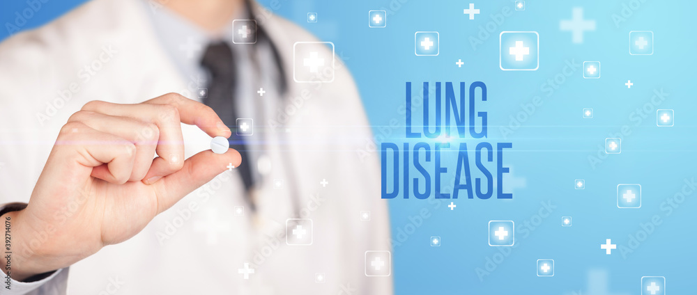 Close-up of a doctor giving a pill with LUNG DISEASE inscription, medical concept Close-up of a doctor giving a pill with LUNG DISEASE inscription, medical concept