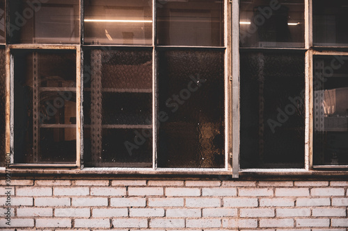 An abstract  old  beige brick wall with old factory windows  can be used as a background