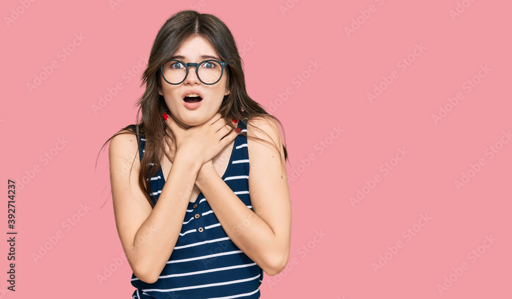 Young beautiful caucasian girl wearing casual clothes and glasses shouting and suffocate because painful strangle. health problem. asphyxiate and suicide concept.