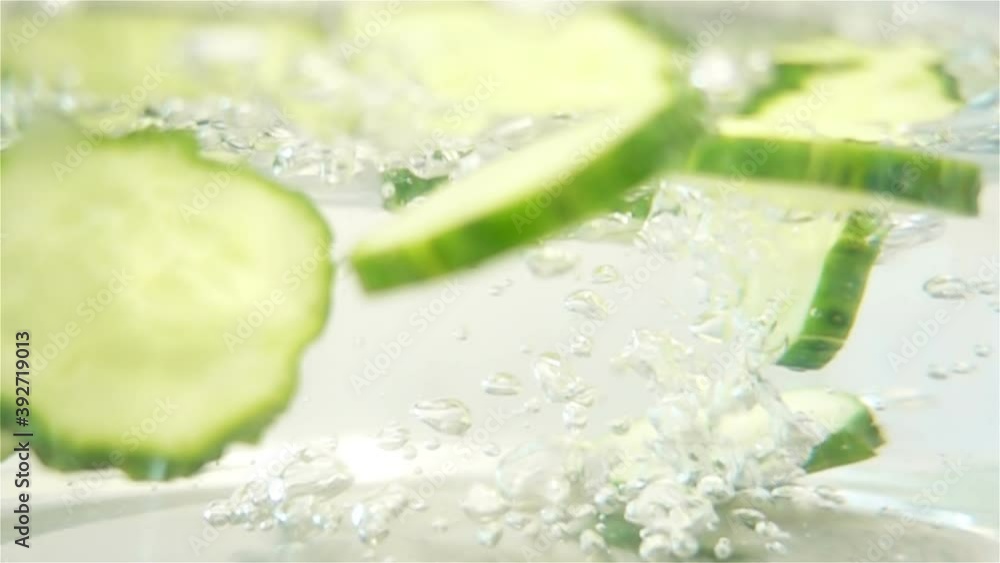 Sliced Cucumber Pieces in Water in Slow Motion Sliced Cucumber Pieces in Water in Slow Motion