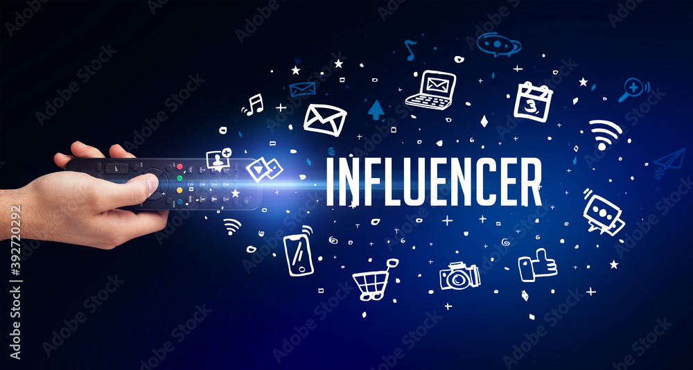 hand holding wireless peripheral with INFLUENCER inscription, social media concept hand holding wireless peripheral with INFLUENCER inscription, social media concept