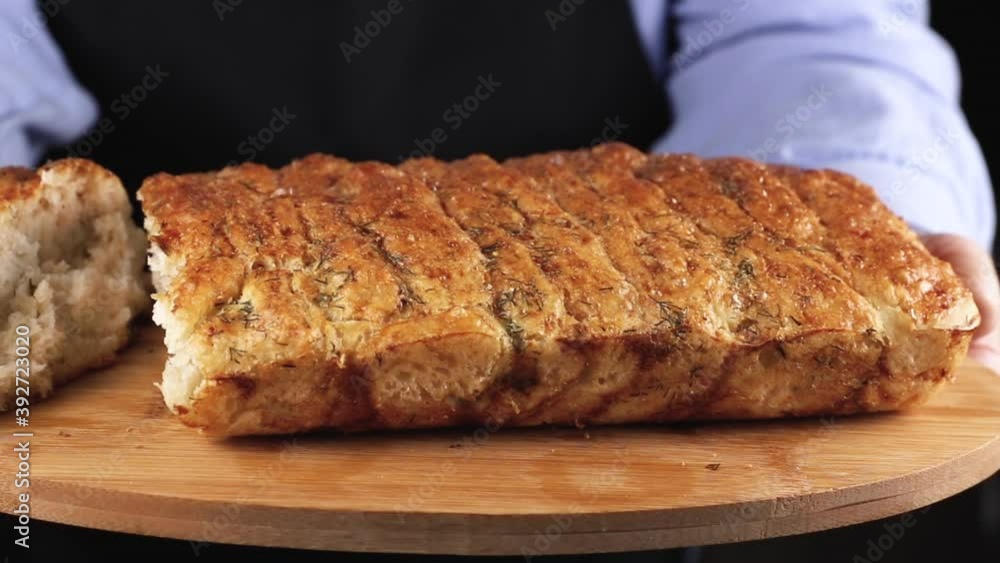 female chef holding a fresh baked bread with wooden cutting board. concept of homemade bakery female chef holding a fresh baked bread with wooden cutting board. concept of homemade bakery