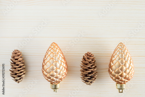 Cones on wooden background. Opposites concept. New versus old, natural versus artificial. 
