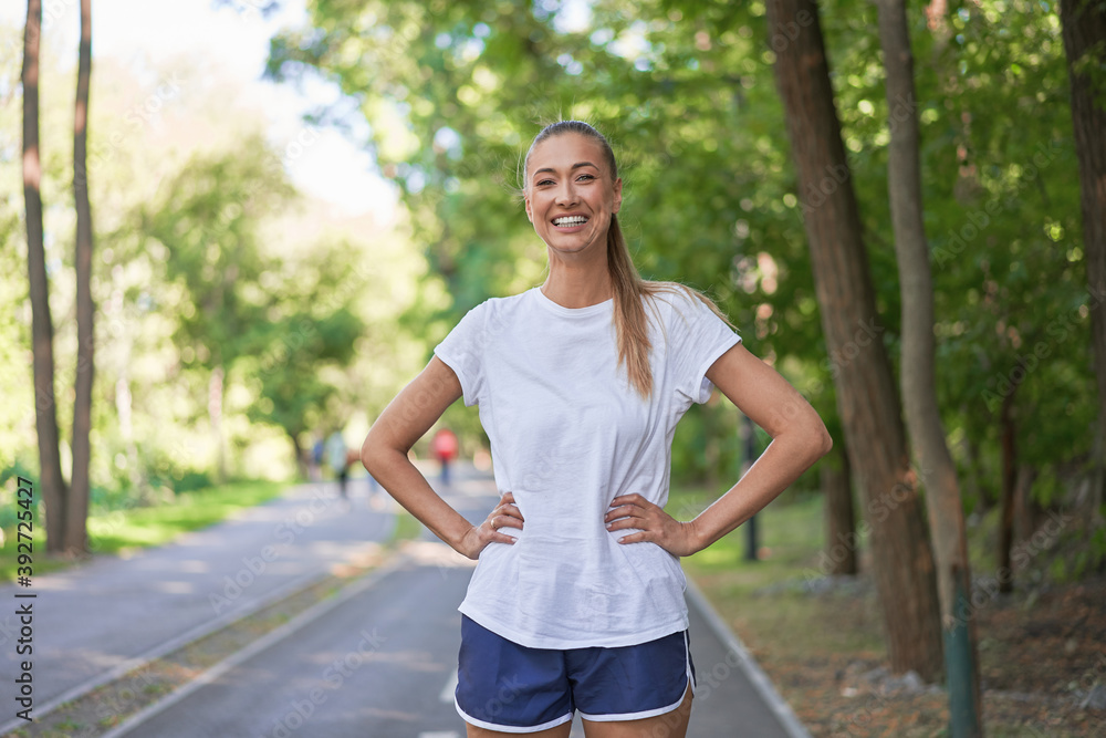 Woman runner standing before exercising summer park morning Woman runner standing before exercising summer park morning