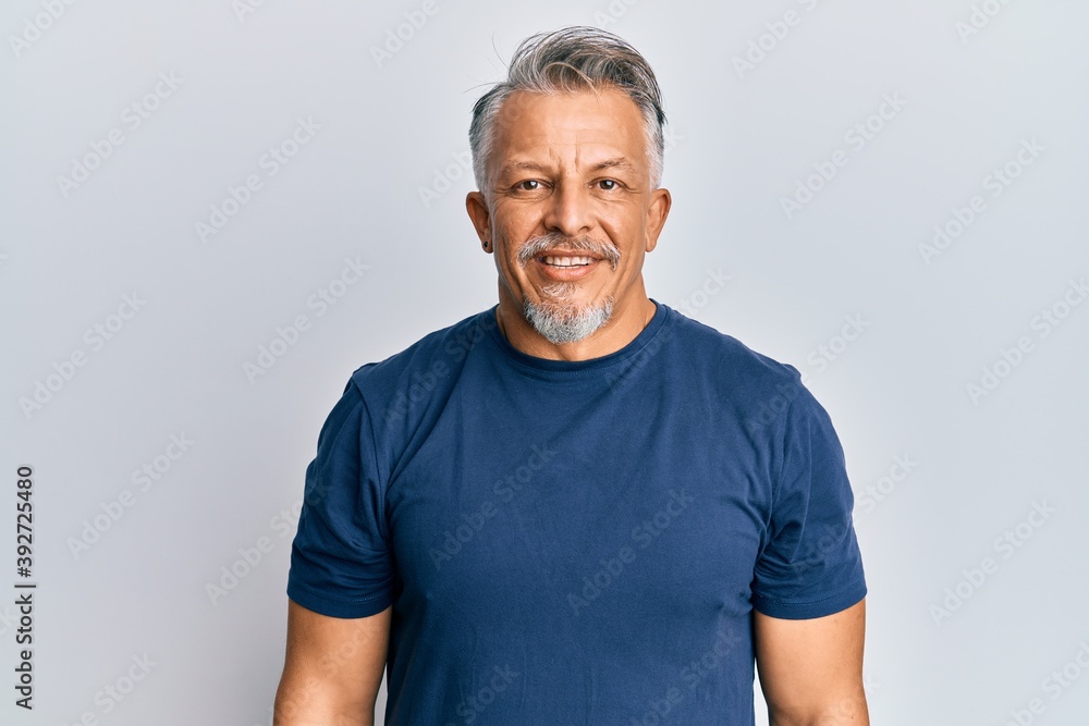 Middle age grey-haired man wearing casual clothes with a happy and cool smile on face. lucky person. Middle age grey-haired man wearing casual clothes with a happy and cool smile on face. lucky person.