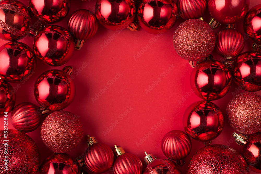 Christmas is coming concept. Top above overhead view close up photo of beautifully decorated red baubles frame isolated on red background with copyspace in center Christmas is coming concept. Top above overhead view close up photo of beautifully decorated red baubles frame isolated on red background with copyspace in center