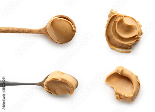 Set of Peanut butter in spoons isolated on white background, top view