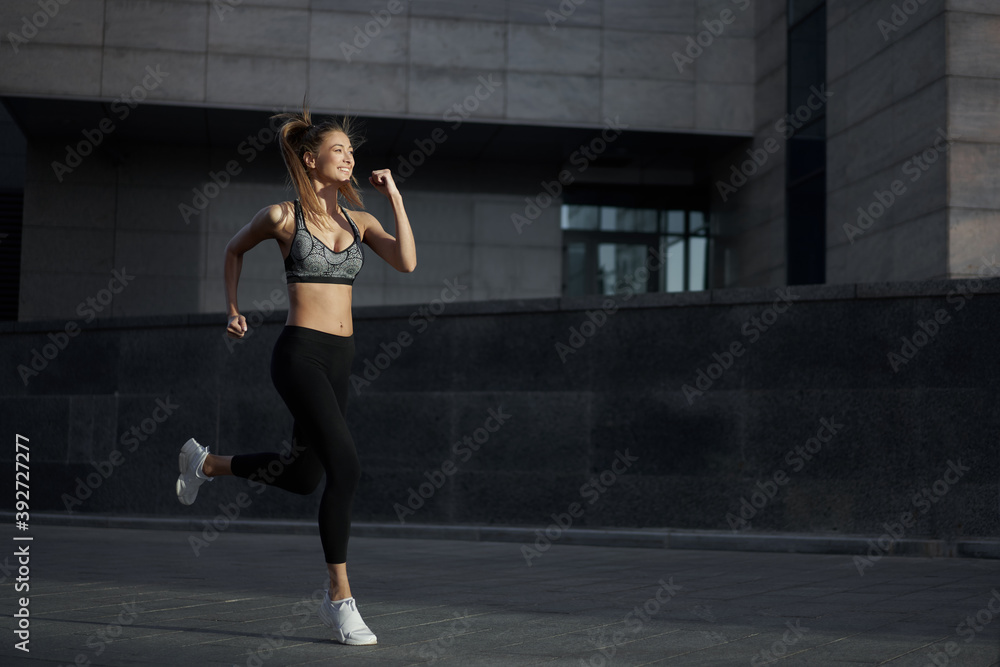 Woman running urban city street background Woman running urban city street background